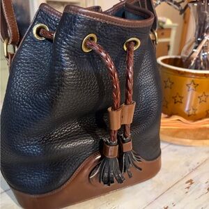 Dooney & Bourke drawstring leather bag in excellent condition. No signs of wear.